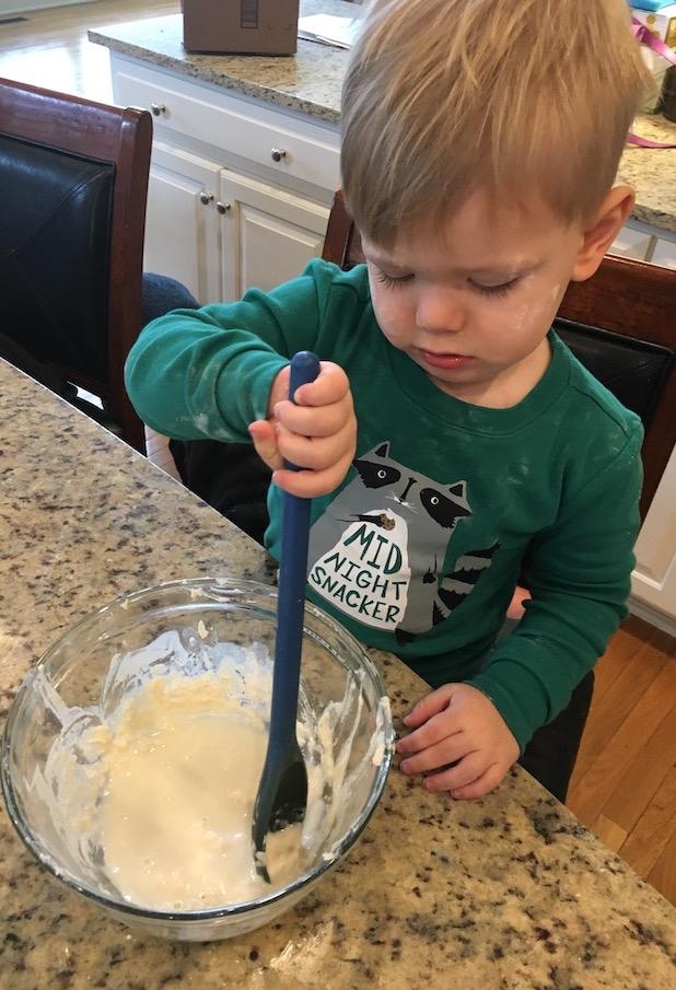 child stirring pancake batter