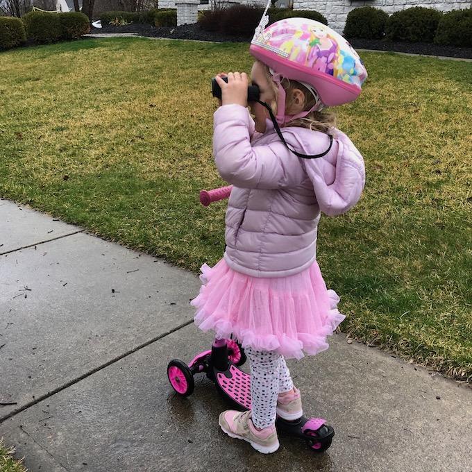 At-Home Activities For Kids 3 toddler on a scooter with binoculars